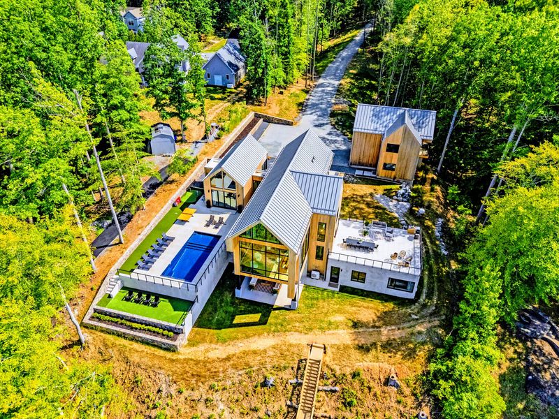 Aerial View - Forest privacy with open water just beyond the property.