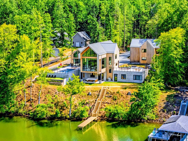 Aerial View - A modern retreat set along the wooded shoreline.