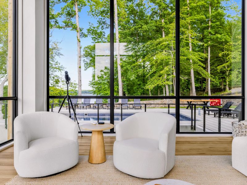Great Room - Vaulted ceilings and a wall of glass frame the lake, keeping the whole group connected.