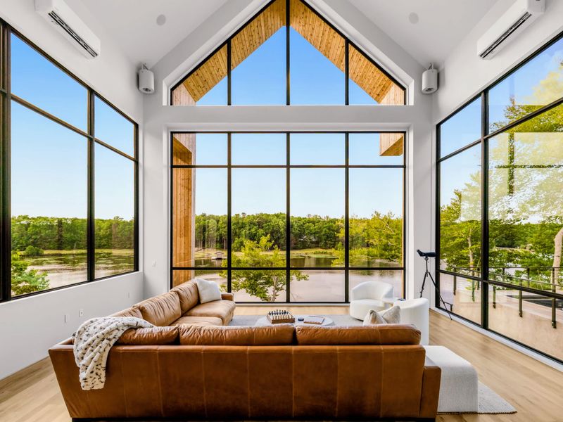 Great Room - The vaulted gable of glass is the home's signature, lit by the changing sky.
