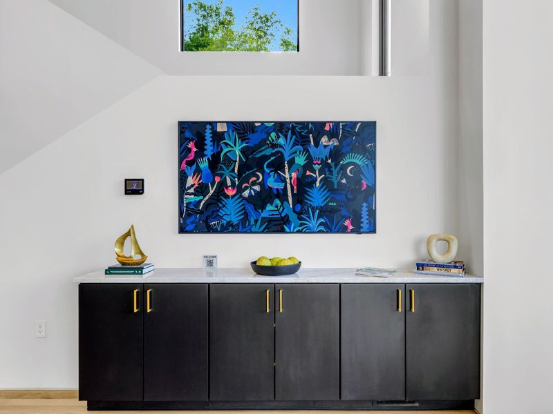 Great Room - A media wall with art and a smart TV anchors the lounge.