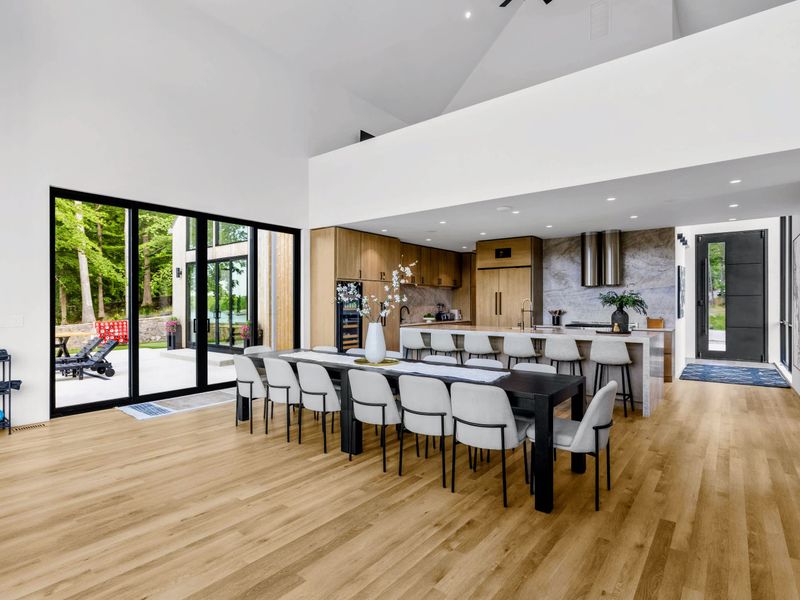 Dining Area - A long table set just off the kitchen, the whole group seated together.