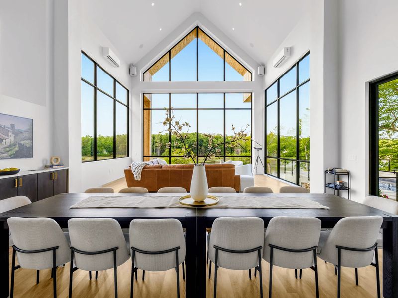 Dining Area - The soaring window wall frames the forest while the group shares a meal.