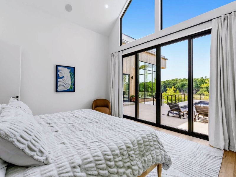 Primary Suite - A king bed with glass doors to the deck, the lake the first thing you see.