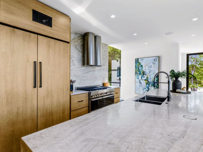 Chef's Kitchen - A quartzite waterfall island and double wall ovens for serious cooking.