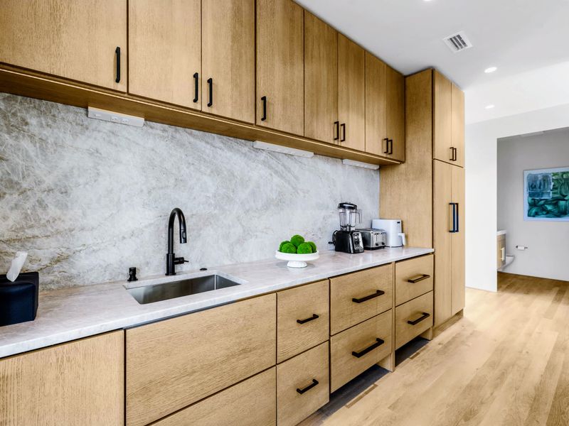 Chef's Kitchen - Quality finishes and a clean galley run with quiet art on the wall.