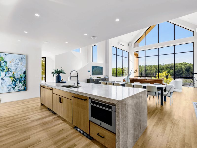 Chef's Kitchen - The island opens to the dining room and the wall of glass beyond.