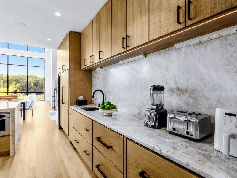 Chef's Kitchen - Small appliances and quartzite counters, stocked for real cooking.