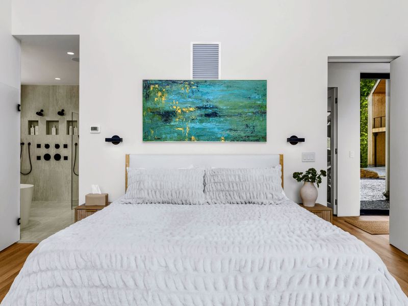 Primary Suite - The bed faces a spa-style ensuite just steps away.