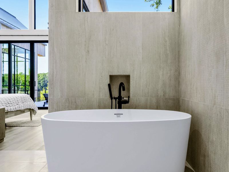 Primary Bath - A sculptural tub with a clean line of sight back to the suite.