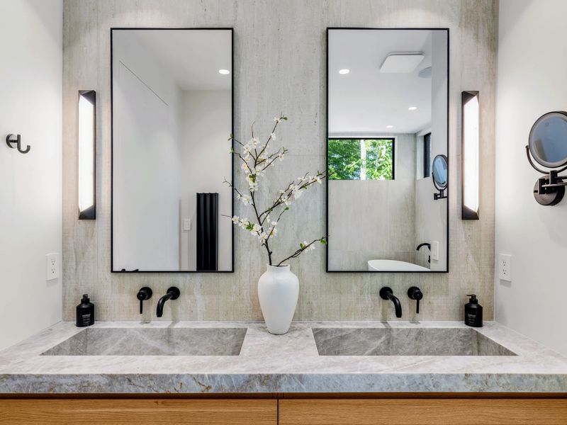 Primary Bath - Side-by-side vanities and stone counters for two unhurried morning routines.