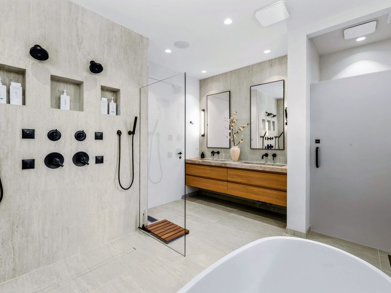Primary Bath - A multi-jet walk-in shower beside the double vanity.
