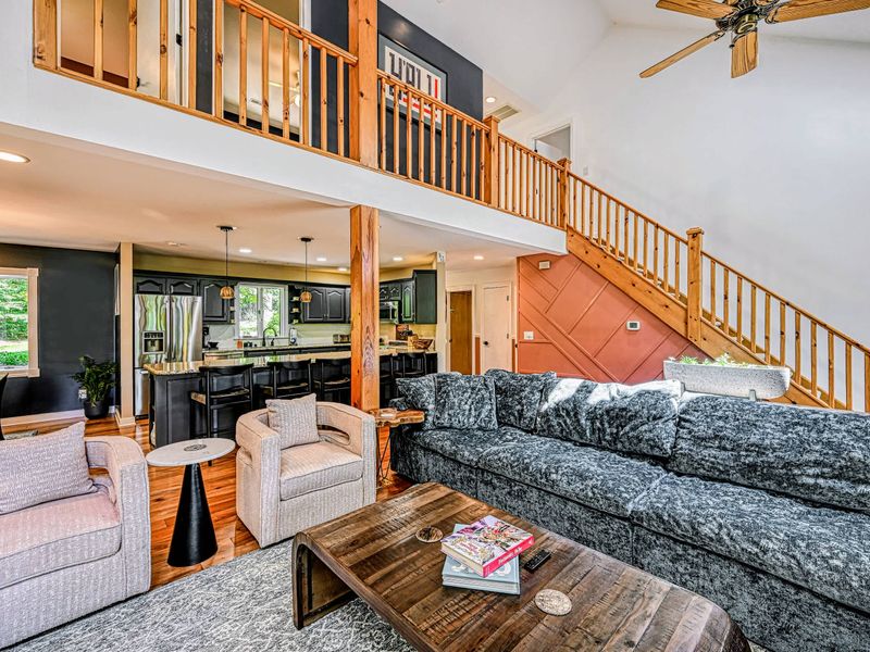 Open Living - A deep sectional and swivel chairs anchor the open living area beneath the loft, flowing into the kitchen.