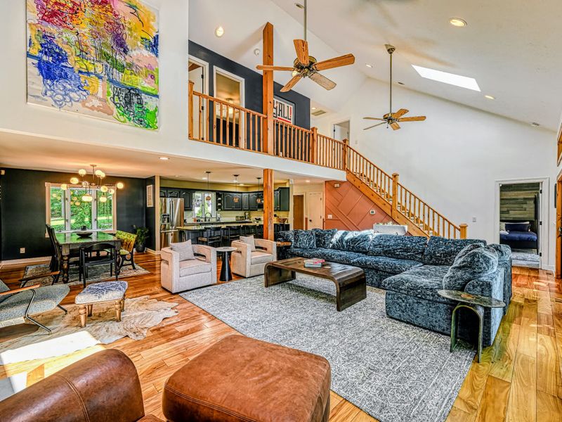 Open Concept - The great room opens to the dining area and kitchen beneath a soaring vaulted ceiling and loft.