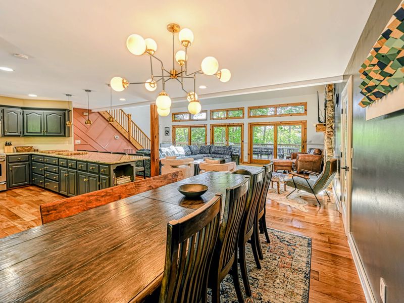 Gather to Eat - The dining table sits open to the kitchen and great room, the whole main level connected for easy gatherings.