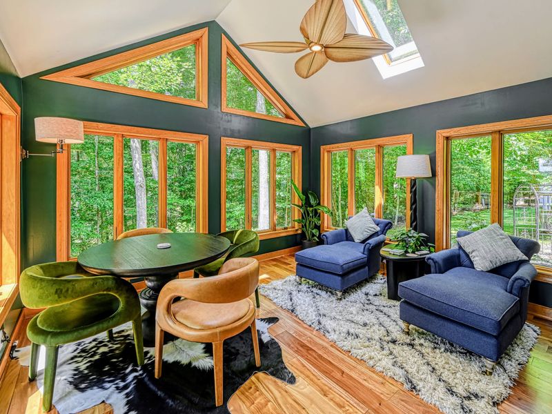 Sun Room Seating - Sink into the blue lounge chairs or gather at the round table as light pours through the wraparound windows.