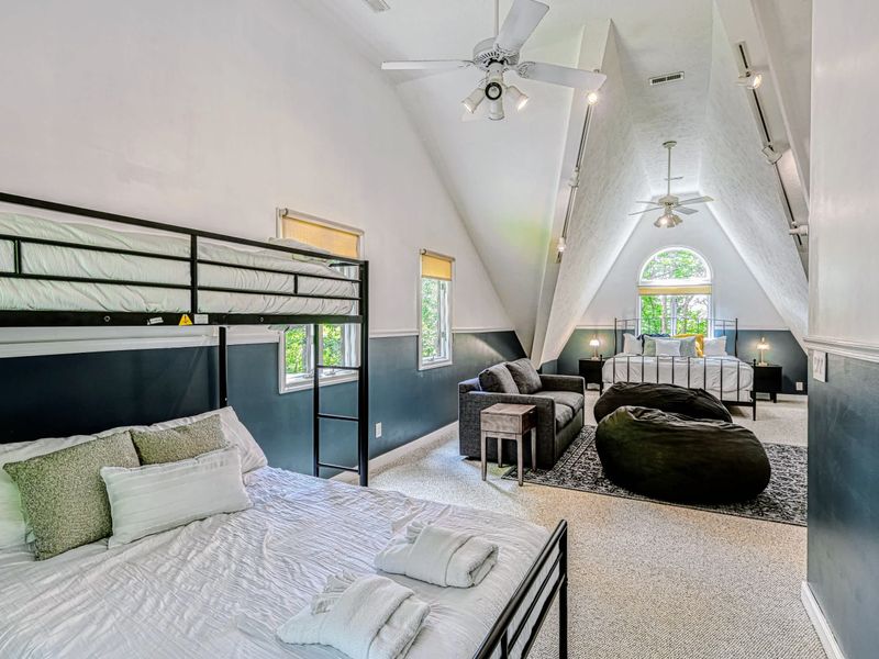 Bedroom 4 - A vaulted A-frame room with a king bed, a bunk, and a lounge, the room kids claim first.