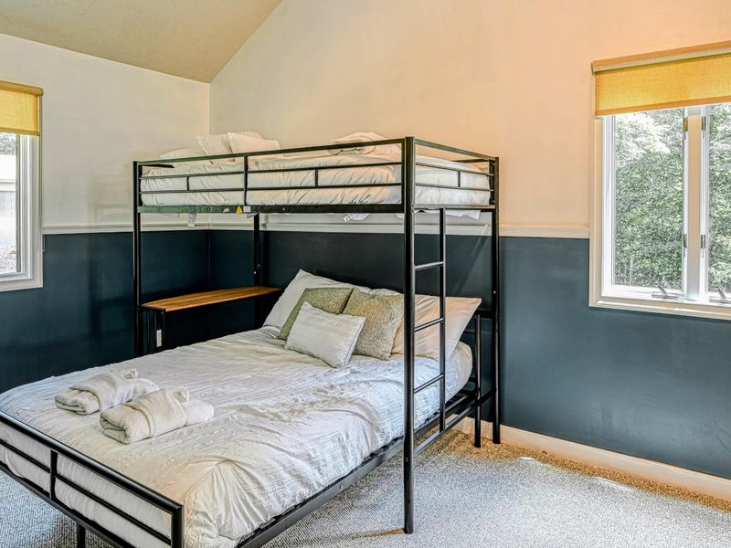 Bunk Bed - A sturdy twin-over-full bunk with a fold-down desk, the spot younger guests claim first.