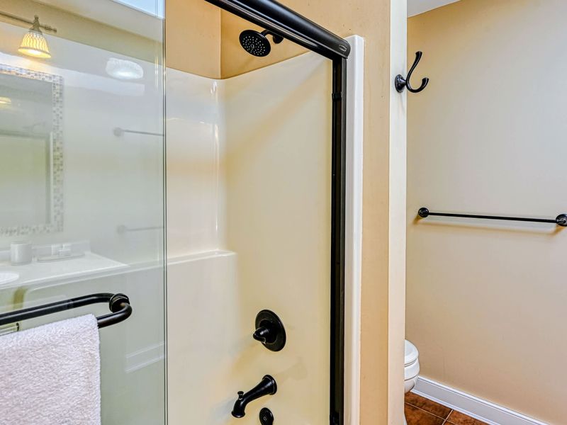 Shower and Tub - A combined tub and shower with oil-rubbed fixtures serves the upper-level bedrooms.