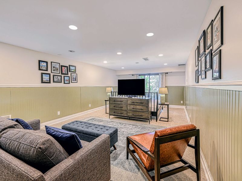 Lower-Level Living Room - A second living space downstairs with comfortable seating and a smart TV.