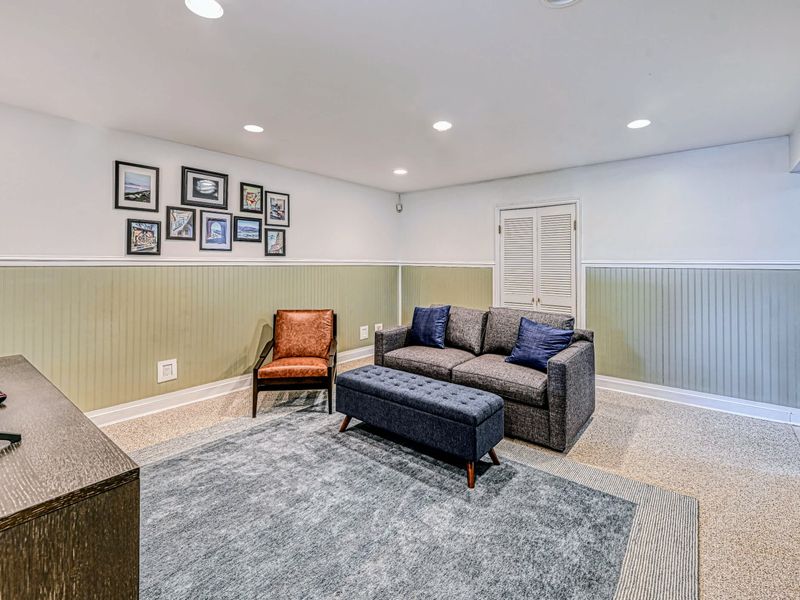 Downstairs Hangout - Sofas, lounge chairs, and an ottoman make this the easy spot for movie night.