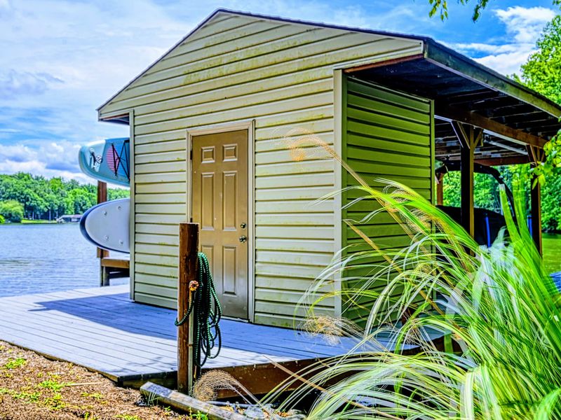 Boathouse - A covered boathouse sits at the water's edge, shade for the gear and a launch point for the day.