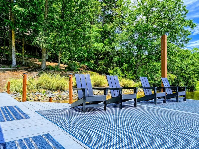 Dock Seating - A row of Adirondack chairs on the open dock, the spot for a slow afternoon by the cove.