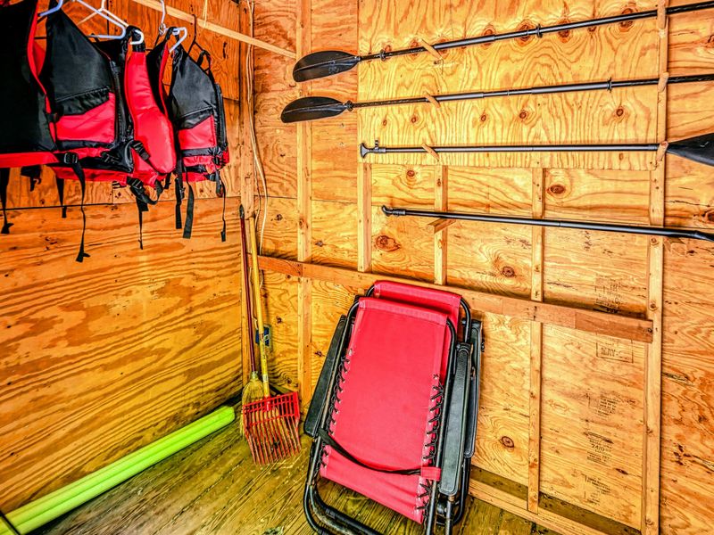 Boathouse Gear - Life jackets and paddles stocked and ready inside the boathouse.