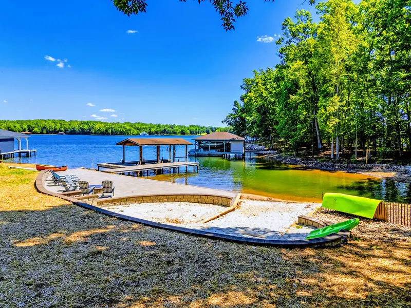 Backyard & Beach - A soft sandy beach in a shallow, swimmable cove, shaded by a weeping willow.