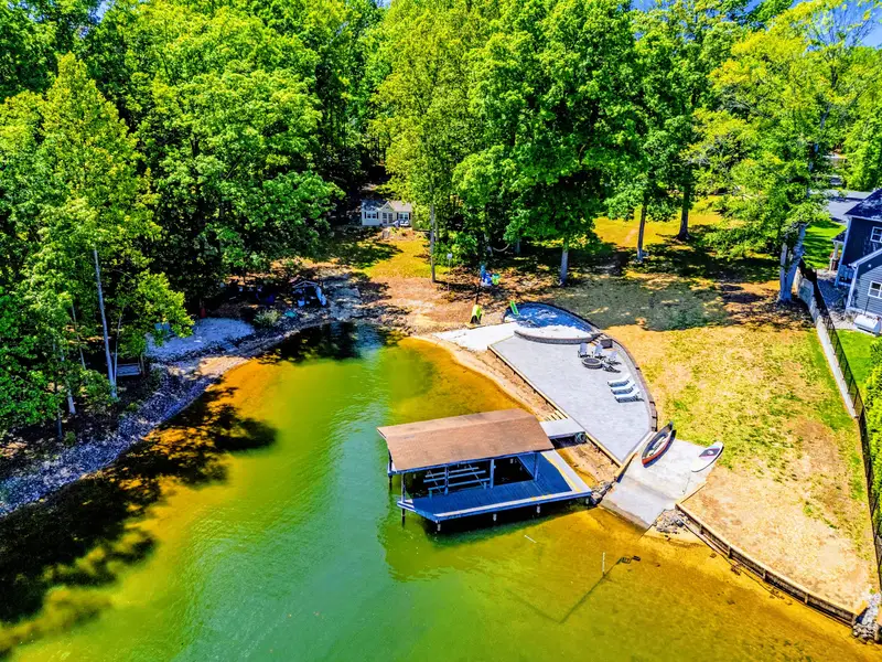Dock - Step off the lawn and onto the water, with shallow, swimmable cove just beyond.