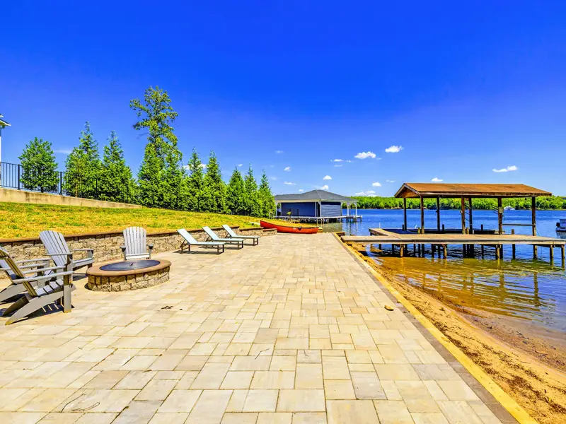 Dock - The full waterfront setup: dock, covered lift, and a private boat ramp just to the left.