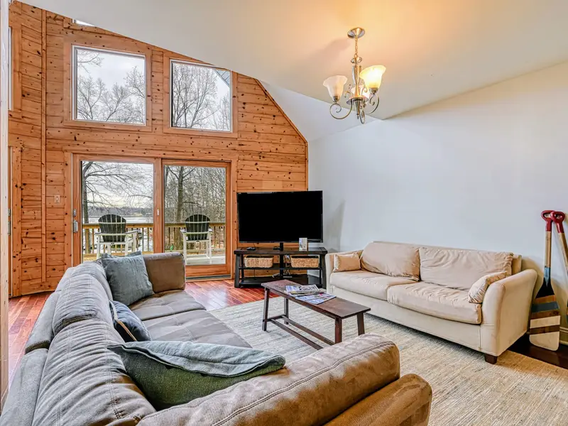 Great Room - Soaring A-frame ceilings and a wall of windows keep the whole group connected with the lake in view.
