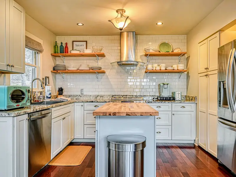 Kitchen - Stainless appliances, open shelving, and plenty of counter space for cooking together.
