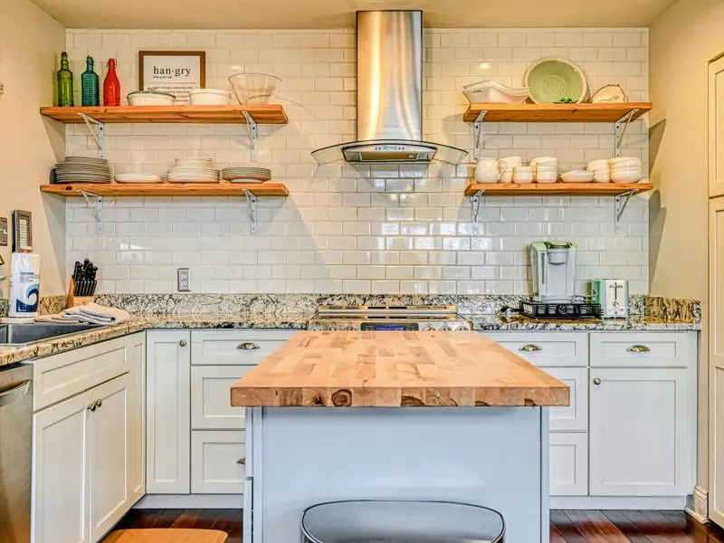 Kitchen - A butcher-block island anchors the space, with room for everyone to pitch in.