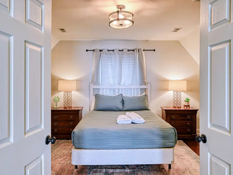 Primary Suite - Bright windows and a serene palette set the tone for an easy night's sleep.