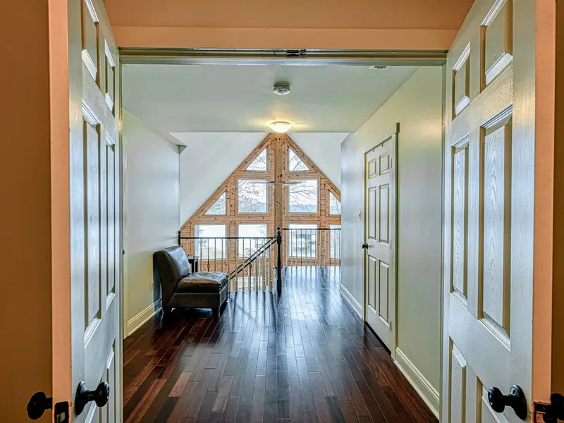 Primary Suite - Vaulted ceilings and soft linens make this upstairs retreat a restful escape.