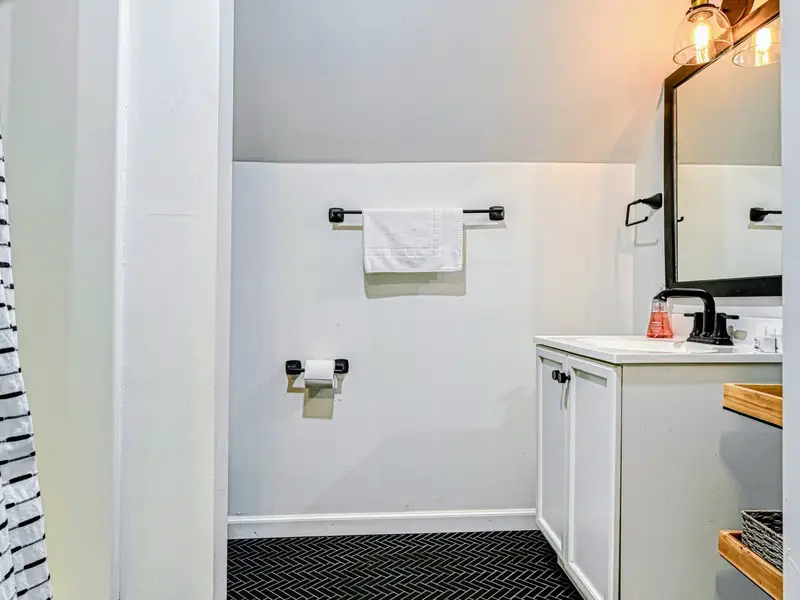 Guest Suite - A tidy full bath serves the private suite above the garage.