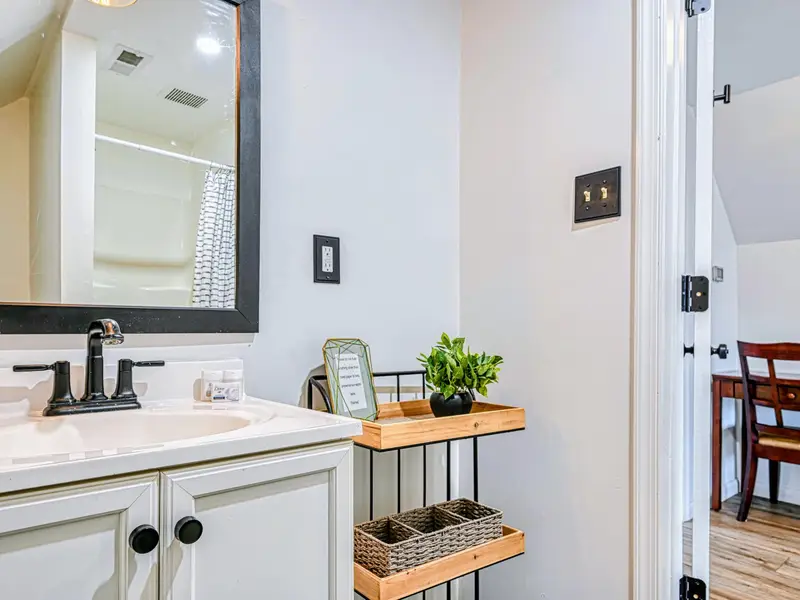 Guest Suite - A vanity with modern fixtures finishes the suite's full bath.