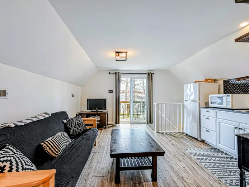 Guest Suite - A comfortable living area with seating and a kitchenette, perfect for grandparents or a couple.