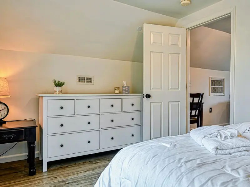 Guest Suite - A dresser and calm palette complete the private guest suite bedroom.