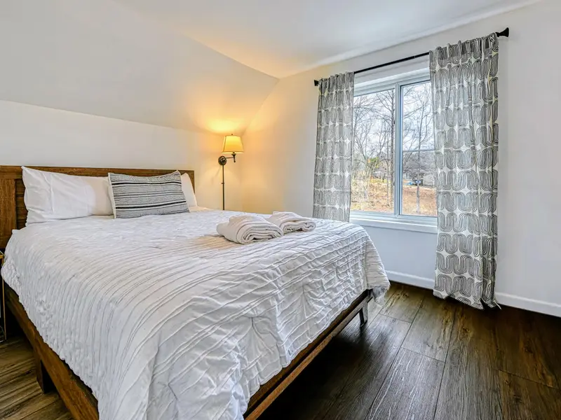 Guest Suite - The suite's queen bedroom is bright and private, a quiet corner all its own.