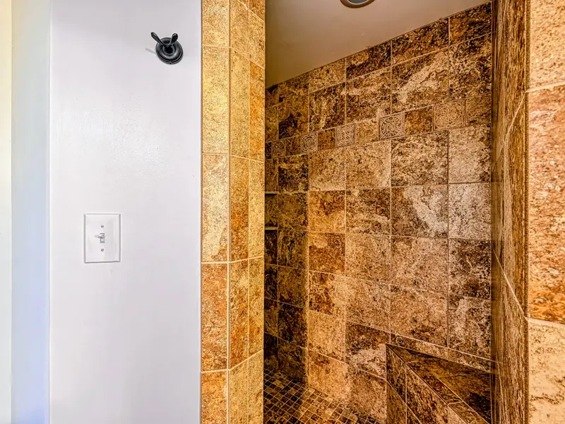 Bathroom - Warm wood tones and a tidy vanity make this bath feel like a retreat.