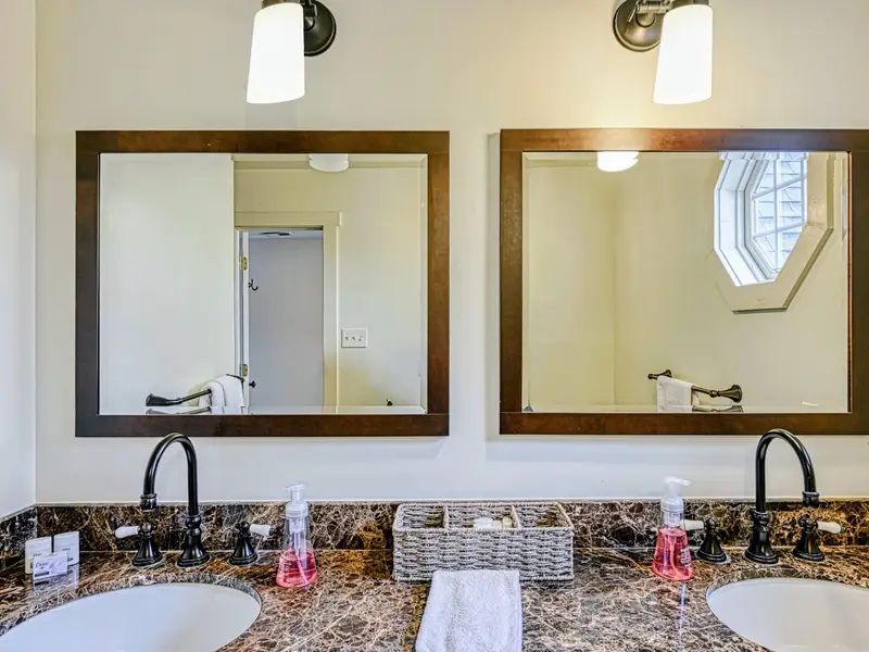 Bathroom - Twin mirrors and a double vanity give everyone space to get ready.