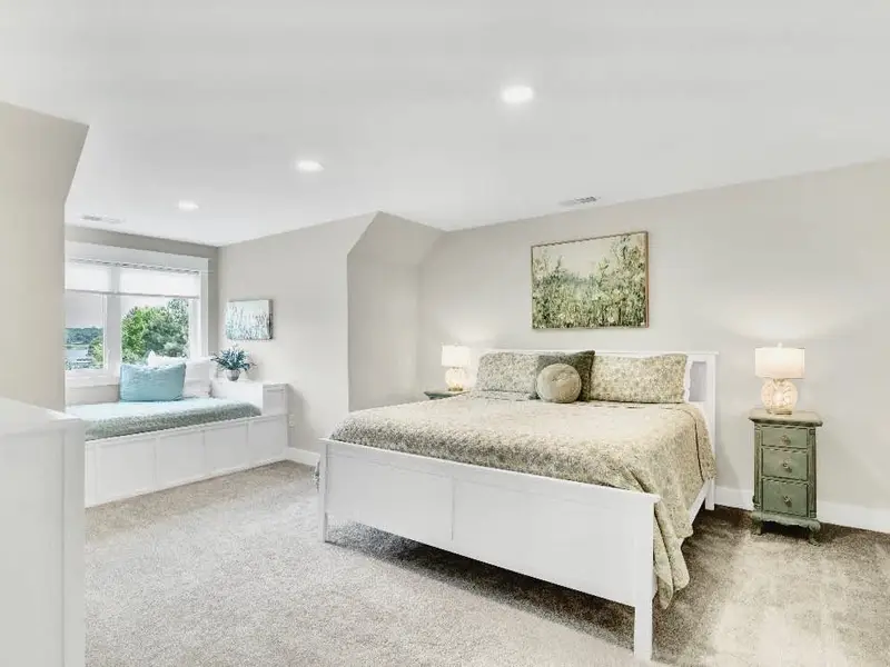 Upper King suite -What sets the two upper king suites apart is not only their stunning lake views &  full baths, but also their charming full-size window beds, perfect for parents traveling with children who want the comfort of sleeping together!