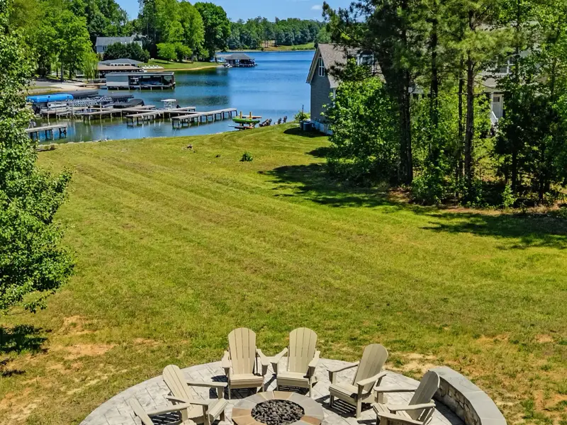 Fire Pit & Lake - The stone fire pit circle overlooks the cove and community docks, an easy walk down from the lawn to the water's edge.