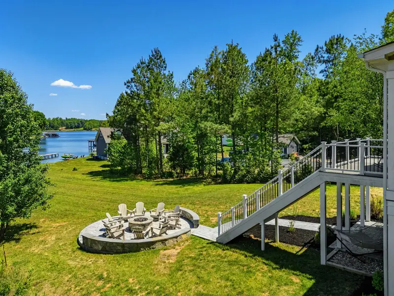 Backyard View - From the deck stairs, the lawn steps down to the fire pit patio and out to the quiet cove and neighboring docks.
