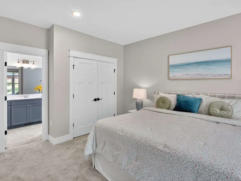A second main-level king suite offers comfort and convenience, featuring plush high-end bedding, a private ensuite full bath in soothing warm blues, all-new furnishings, and thoughtfully curated local antiques for added charm.