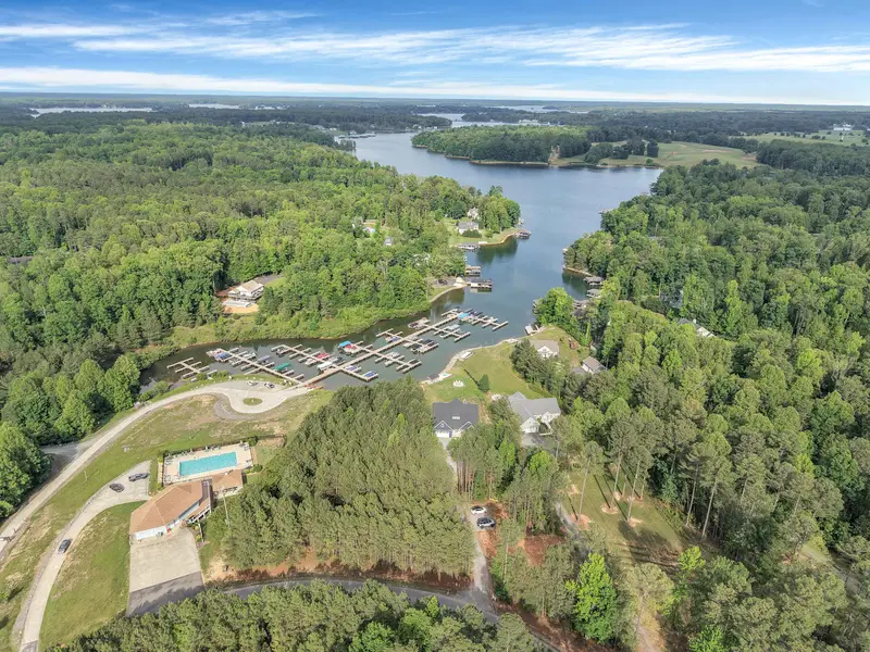 Aerial shot of the community pool/clubhouse with gorgeous lake views and Blueberry Bay right next door. Lake views are everywhere!