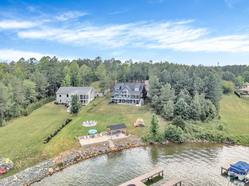 Aerial view of Blueberry Bay with beautiful lake views private sandy beach, fire pit overlooking the lake, hot tub and right next to the community pool, marina, clubhouse, tennis/pickleball courts.