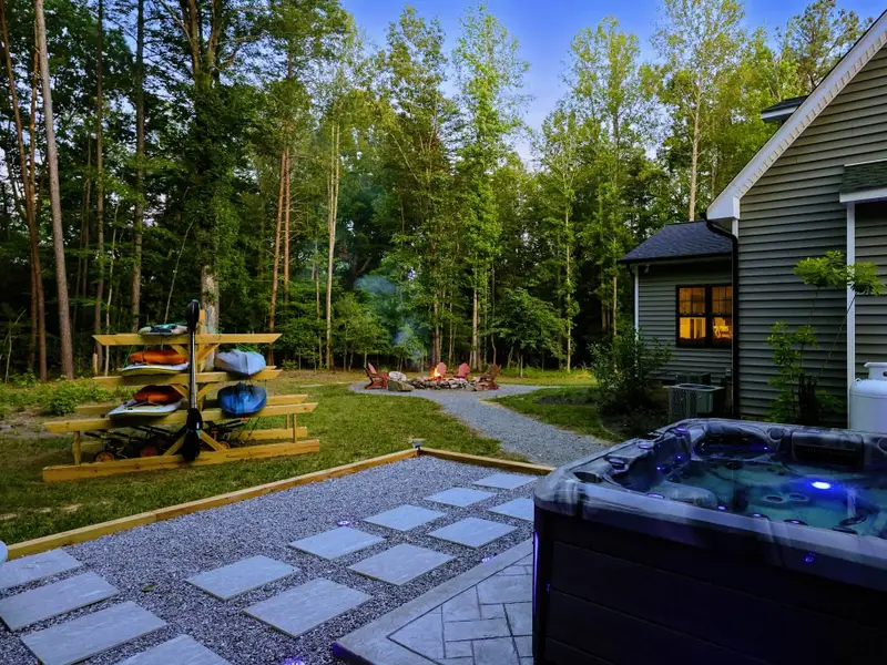 Hot Tub - A twilight soak with the home aglow behind you and the fire pit just steps away.